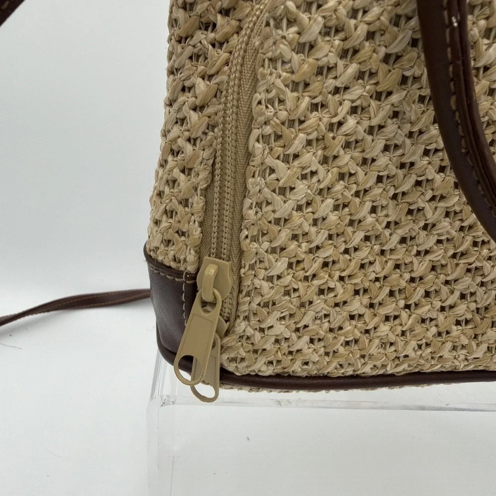 Rosetti straw tote handbag with brown faux leather trim‎ and top handles.